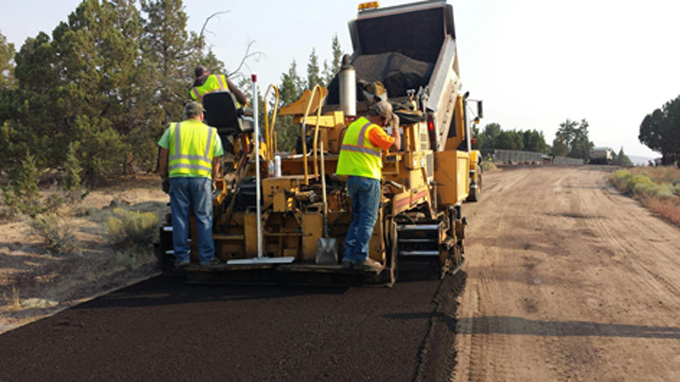 workers repairing a concrete road